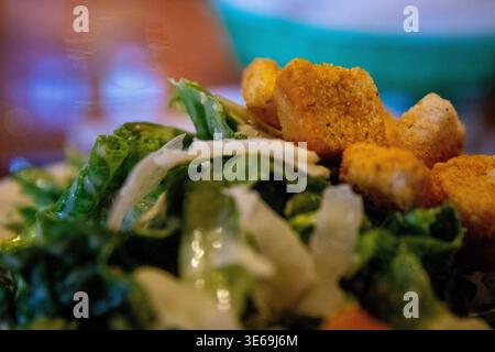Croutons on a Caesar salad with parmesan cheese on top Stock Photo