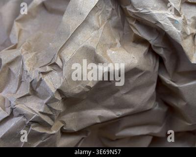 Crumpled brown kraft paper showing rough recycled texture and abstract patterns Stock Photo