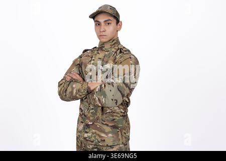 Military man in camouflage standing with crossed arms Stock Photo