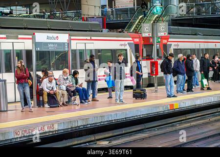 Madrid Spain,Estacion de Madrid-Puerta de Atocha-Almudena Grandes,main railway station,high speed rail hub AVE,platform waiting passengers,people men Stock Photo