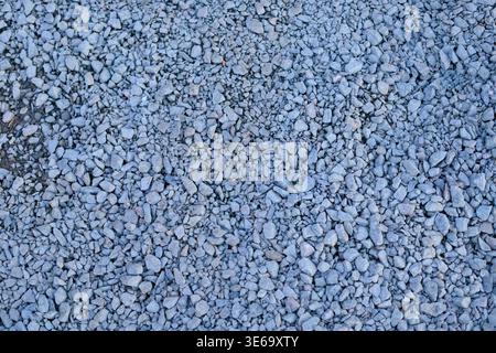 Crushed stone texture for construction and landscaping. Natural gray granite gravel used as a base for roads, paths, and industrial drainage systems i Stock Photo