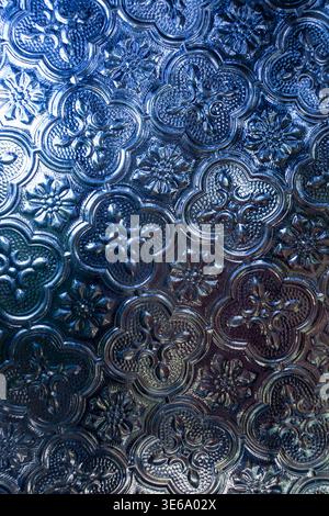 Elegant embossed glass pattern with floral designs in warm golden light Stock Photo