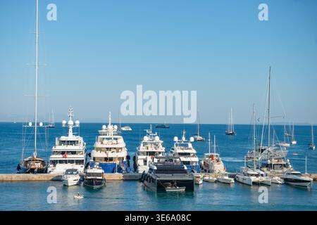 A row of luxury yachts and catamarans moored at a pier in Corfu. Summer nautical scene in the Ionian Sea, Greece, taken on July 9, 2023. Stock Photo
