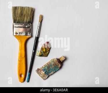 Artist's paintbrushes and paint tubes on white background Stock Photo