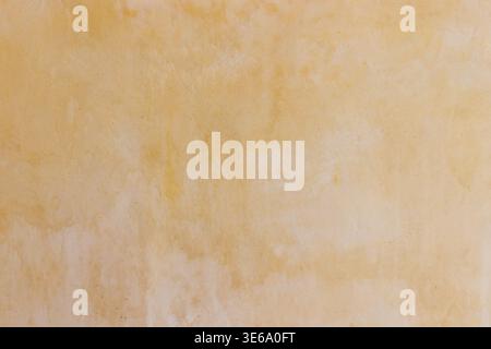 Warm beige textured background with soft golden hues Stock Photo