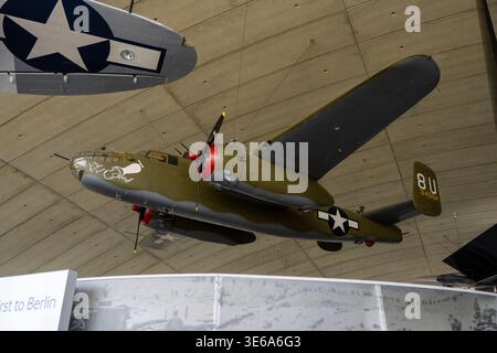 Cambridge, UK - 7 Apr 24: Nose of a North American B-25 Mitchell bomber displayed suspended at IWM Duxford AirSpace, featuring vintage nose art and US Stock Photo