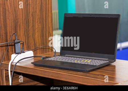 Modern open laptop inside office table interior Stock Photo