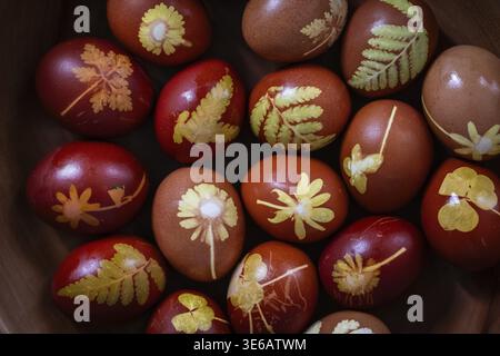 Eggs with decorative plant patterns in various shades of natural red Stock Photo