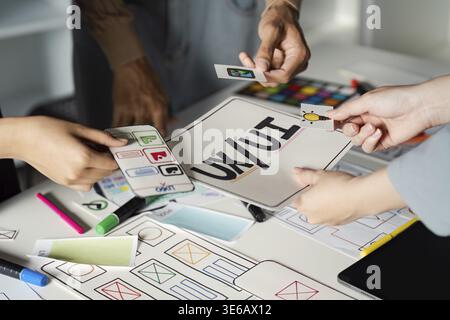 Team collaborating on UX UI design, sharing ideas and concepts for innovative digital solutions in a creative brainstorming session Stock Photo