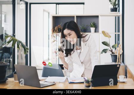 Asian business woman having video call with business team to consult about business plan of company. Online team meeting video conference Stock Photo