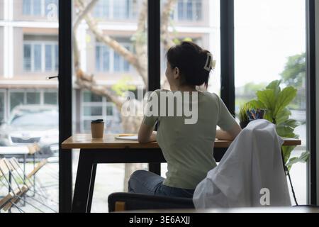 Beautiful asian young creative woman sitting at the home office. work from home concept Stock Photo