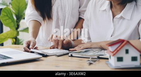 Before paying the house bill via internet application, the roommate assists in checking the bill Stock Photo