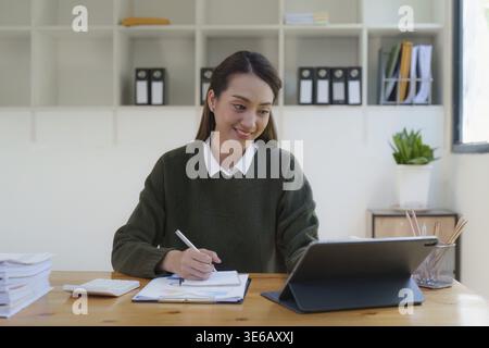 Asian Business woman making prepare presentation or important email of financial. Business Accountant working in home office Stock Photo