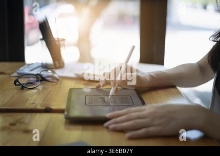 Closeup of female ux developer and ui designer about mobile phone app interface in living room at home.Creative digital development agency concept Stock Photo