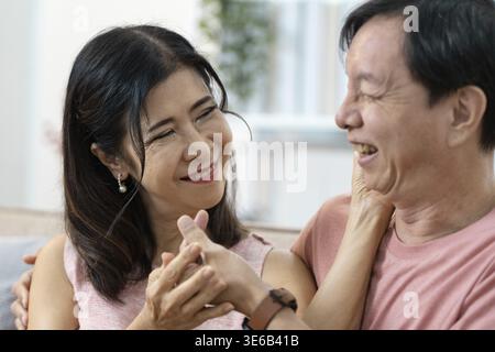 Elderly couple sharing a joyful moment, symbolizing love and companionship in their golden years Stock Photo