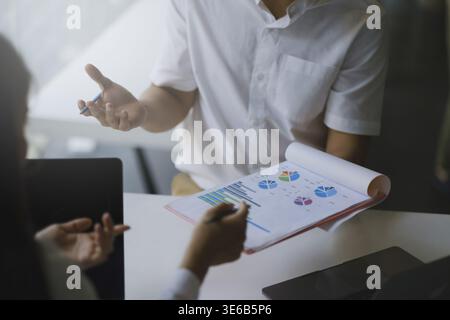 Marketing plan researching. Paperwork on the paperwork on wooden desk in office. Brainstorming Group of people Working Concept Stock Photo