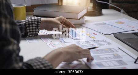 A close-up of an ux ui developer and an ui designer working on a mockup icon interface for a mobile app Stock Photo