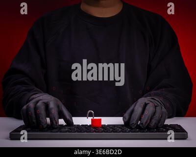Cybersecurity and data breach concept showing anonymous hacker wearing gloves typing on keyboard with digital lock and binary code. Hacking attack, da Stock Photo