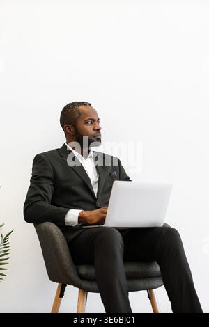 Man in Suit With Laptop Stock Photo