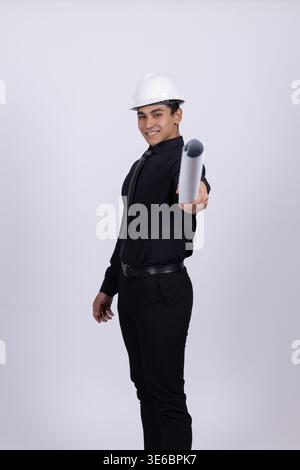 Serious man in black clothes and hardhat holding spray can Stock Photo