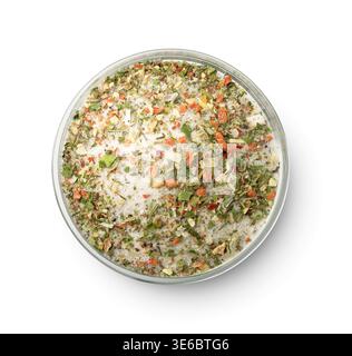 Top view of mixed aromatic salt, spices and herbs in glass bowl isolated on white Stock Photo