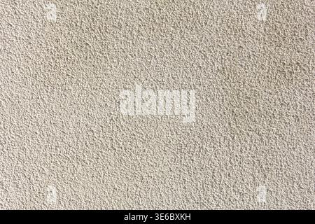 A view of a pebble dash style stucco wall texture, as a background. Stock Photo