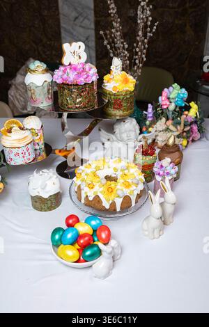 Abundant Easter Table with Decorated Kulichi, Bunny Figurines and Colored Eggs Stock Photo
