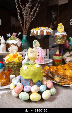 Easter Table: Kulichi in Painted Molds, Decorated Eggs, Pastries, and Figurine Chicks  Stock Photo
