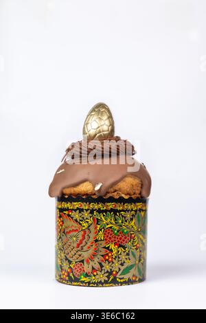 Easter Kulich in Painted Mold with Chocolate Glaze and Golden Egg - Minimalist Festive Dessert Stock Photo