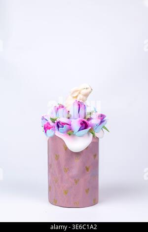 festive Easter cake with a bunny in flowers on a white background Stock Photo