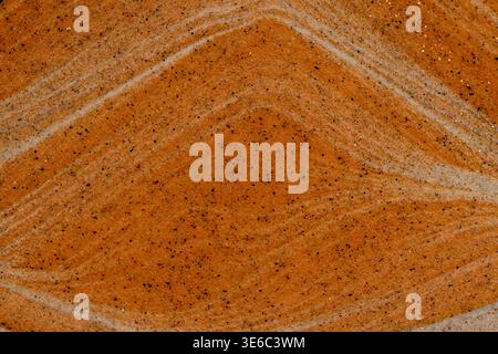 Full frame texture orange and white sand waves with dark speckles and glitter Stock Photo