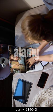 Young woman using laptop and tablet while learning online at home. Stock Photo