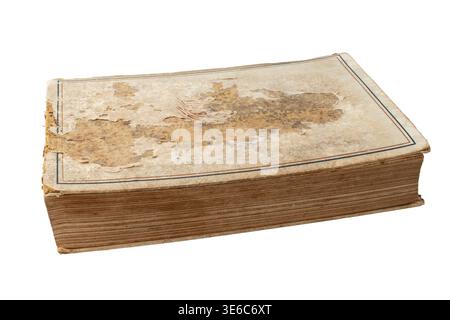 Closed old worn out book with dirty and torn cover and spine lying isolated on white background. Stock Photo