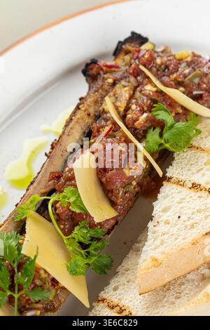 Bone marrow with beef tartare and bread slices Stock Photo
