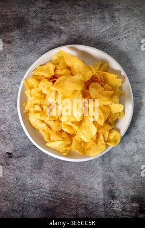 Plate with potato chips seen from above Stock Photo