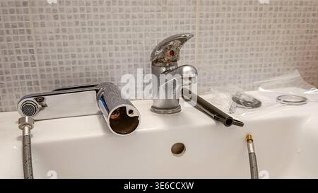 Plumbing Repair Tools Next to Dirty Bathroom Faucet Stock Photo