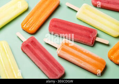 Colorful fruit popsicles on green background Stock Photo