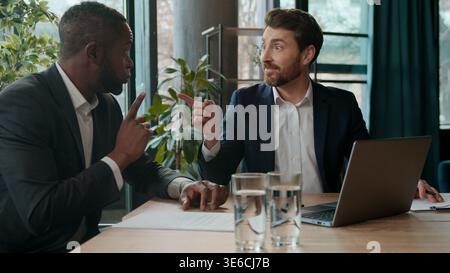 Two business men team in office multiethnic African American businessman sharing good idea Caucasian boss ecxited agree communicating diversity Stock Photo