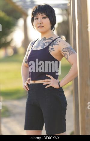 An asian woman with a full body body tattoo, in a japanese style