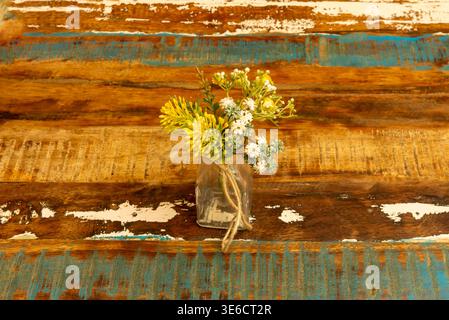 Mini artificial plant made of plastic stone placed in a small recycled tin pot, ideal for decorating desks without needing natural light. Stock Photo