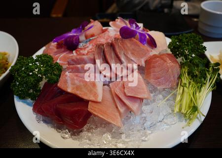 Fresh premium tuna sashimi platter served on crushed ice with garnish Stock Photo