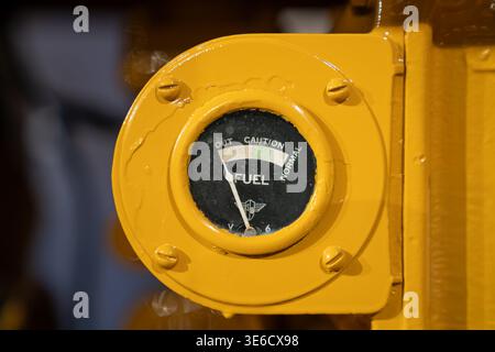 Vintage Tractor Fuel Gauge Close-Up on Yellow Industrial Panel. High quality photo Stock Photo