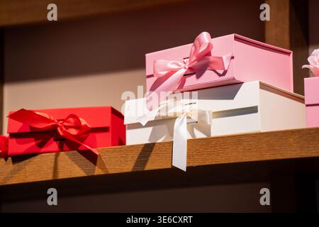 Stylish assorted present boxes with decorative bows on a wood surface, highlighting high quality gift wrapping services for boutique retail and season Stock Photo
