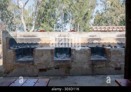 Outdoor barbecue grill station with brick fire pits in campsite park rustic cooking area travel and leisure concept Stock Photo