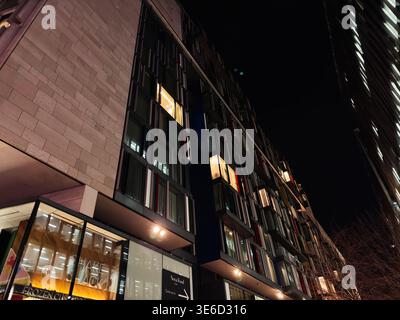 London, UK - February 02, 2026: Illuminated modern building facade photographed at night in London UK, showing repeated windows and urban geometry. Stock Photo