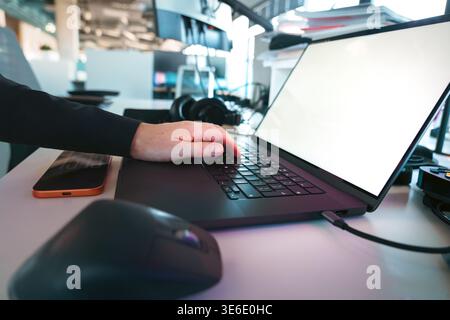 Laptop mockup workspace typing hand blank screen. Modern office environment technology setup productivity concept digital work remote job creative des Stock Photo