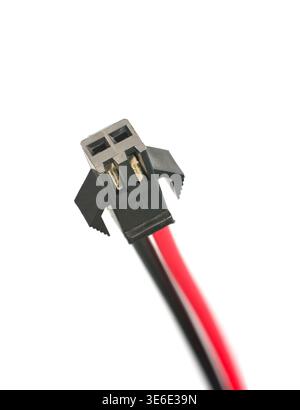two pin black plastic connector isolated white background, connector head with metal terminals and red and black wires attached, closeup view Stock Photo