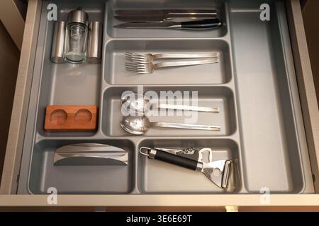 Gray Plastic Tray with Knives, Forks, and Spoons Stock Photo