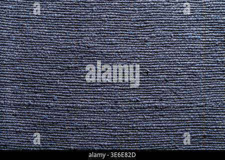A detailed close-up shot of a dark blue woven textile with a distinct horizontal ribbed pattern. Perfect for background, interior design, and fashion Stock Photo