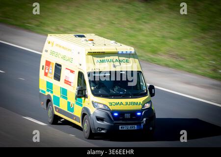 North West Ambulance MV72 XRS speeding along the M65 Motorway, Altham, Hyndburn, Lancashire England with Blue lights. Stock Photo